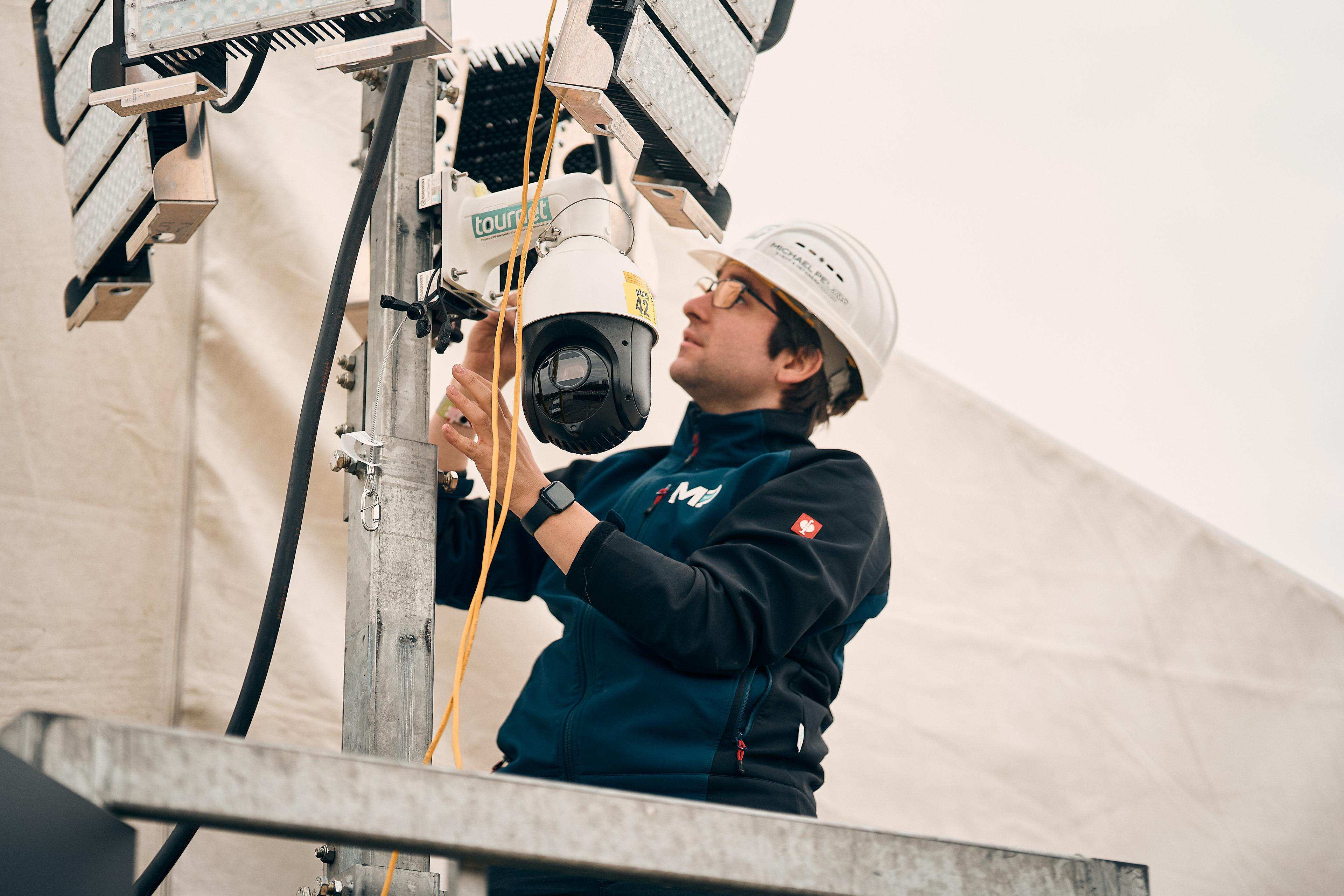 Our Head of Tournet Giacomo installing a PTZ camera on a lighting mast.